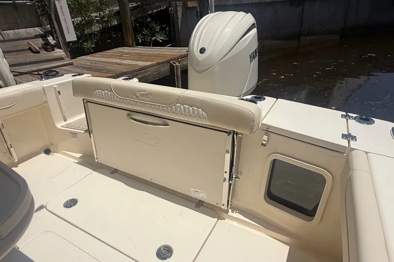 Slide: The Image of 2027 Scout 220 XSF boat interior with Yamaha engine, docked by wooden pier. - 11