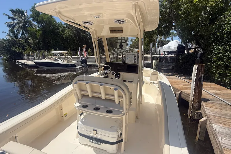 Slide: The Image of 2027 Scout 220 XSF boat docked, featuring a sleek interior and modern controls. - 9