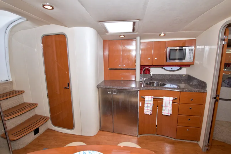 Slide: The Image of Interior of a 2008 Formula 40 Performance Cruiser with modern kitchen amenities. - 33