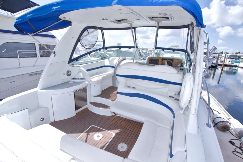 Slide: The Image of 2008 Formula 40 Performance Cruiser with blue canopy, docked at marina. - 16