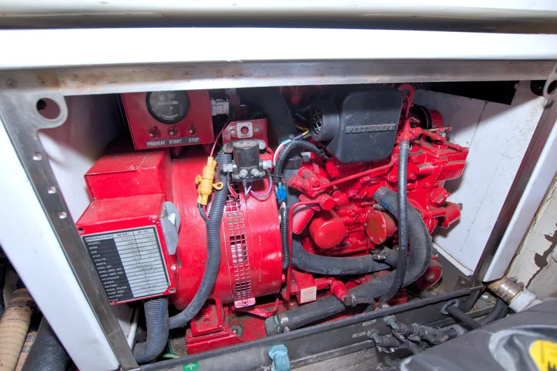 Slide: The Image of Engine compartment of a 2008 Formula 40 Performance Cruiser, featuring a red Westerbeke generator. - 52