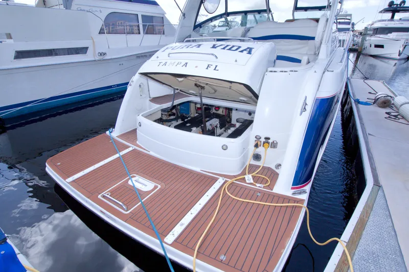 Slide: The Image of 2008 Formula 40 Performance Cruiser docked, showcasing open engine compartment and teak swim platform. - 53