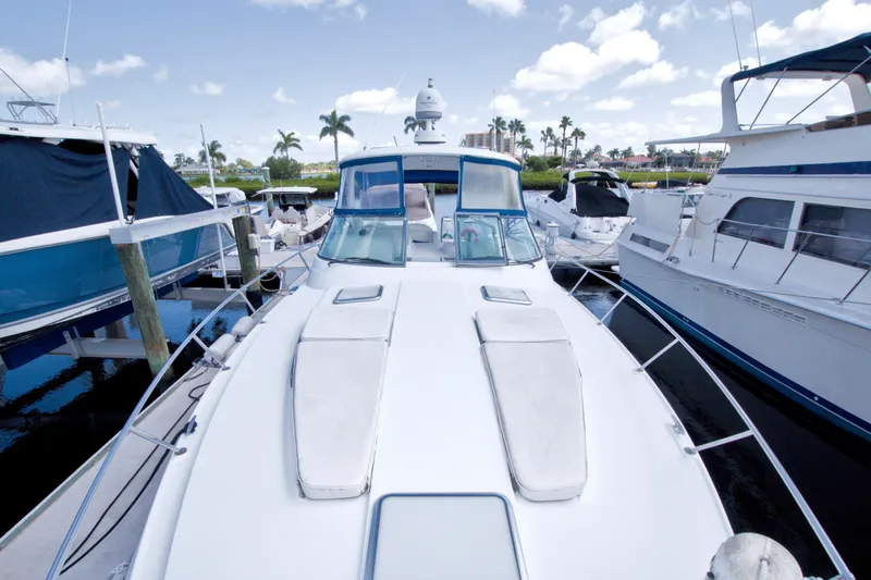 Slide: The Image of 2008 Formula 40 Performance Cruiser docked among other boats, under a clear blue sky. - 27