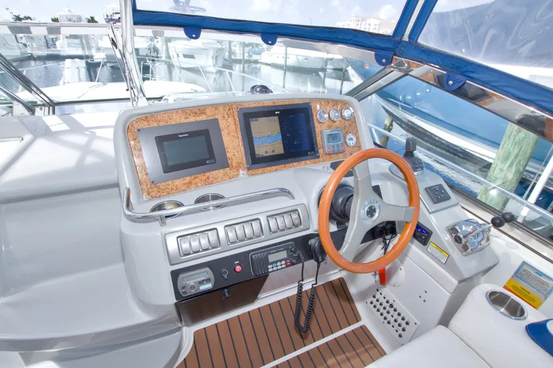 Slide: The Image of Cockpit of 2008 Formula 40 Performance Cruiser with navigation screens and wooden steering wheel. - 22