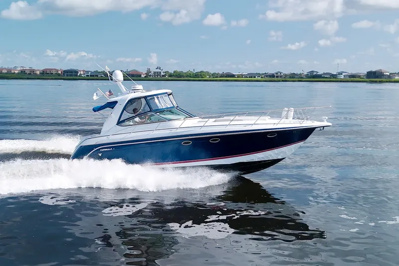 The Image of 2008 Formula 40 Performance Cruiser speeding on a calm lake under a clear sky. - 3