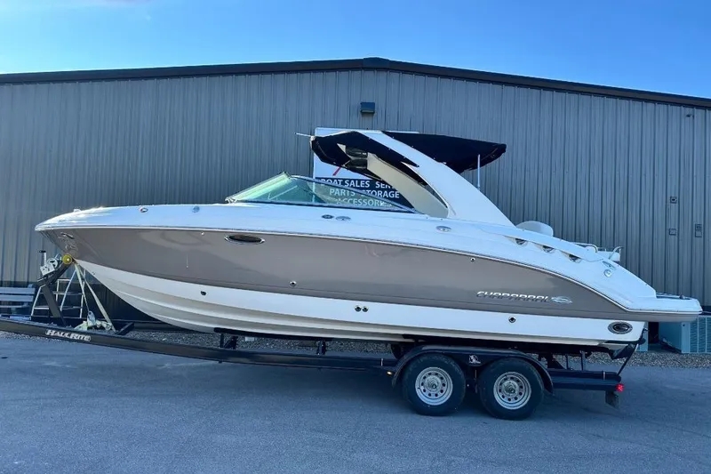Slide: The Image of 2007 Chaparral 276 SSX boat on trailer, parked outside a warehouse. - 1