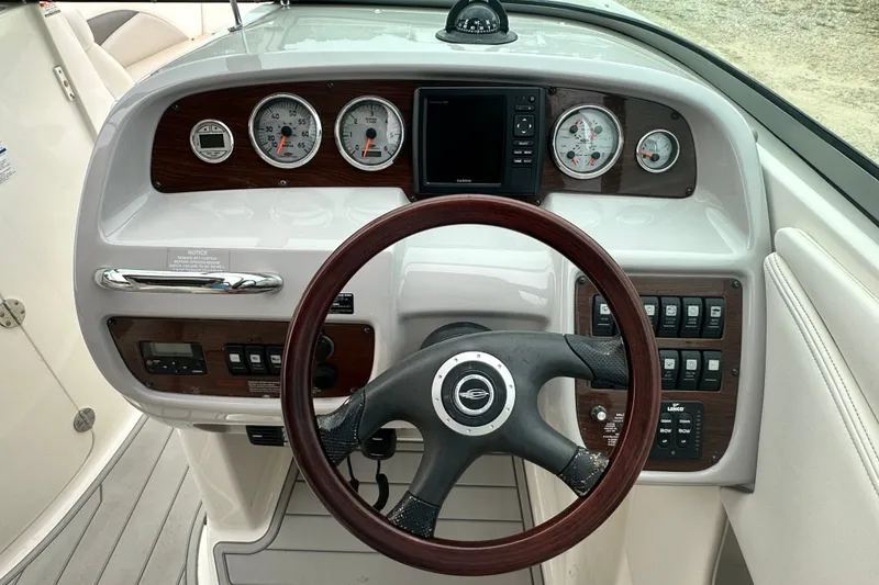 Slide: The Image of Steering console of a 2007 Chaparral 276 SSX boat with gauges and controls. - 12
