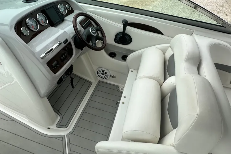 Slide: The Image of 2007 Chaparral 276 SSX boat interior with steering wheel, gauges, and white seating. - 11