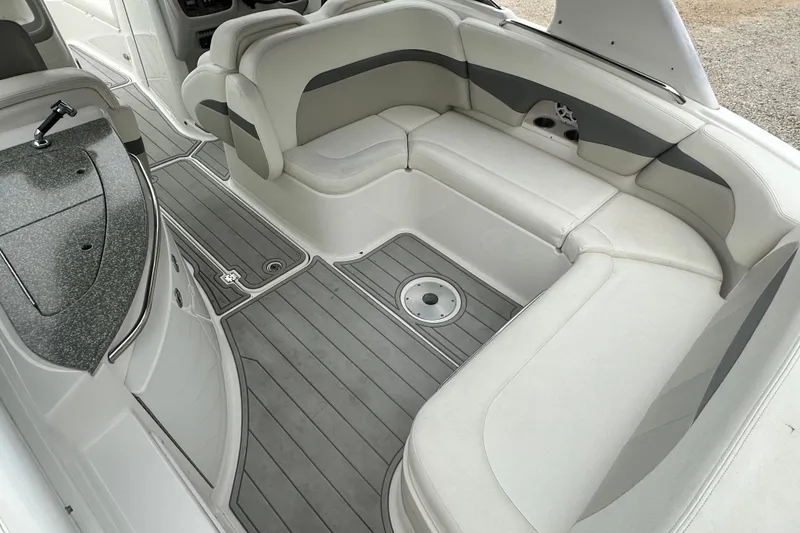 Slide: The Image of 2007 Chaparral 276 SSX boat interior with white seating and gray flooring. - 8