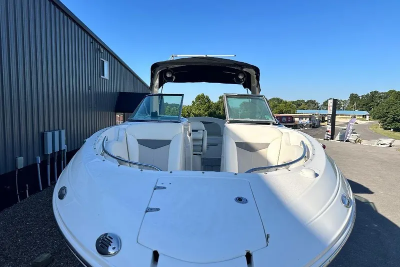 Slide: The Image of 2007 Chaparral 276 SSX boat with open bow seating, parked outdoors. - 6