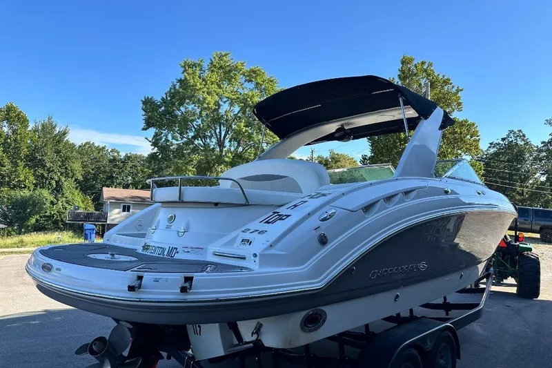 Slide: The Image of 2007 Chaparral 276 SSX boat on trailer, parked outdoors under clear blue sky. - 4