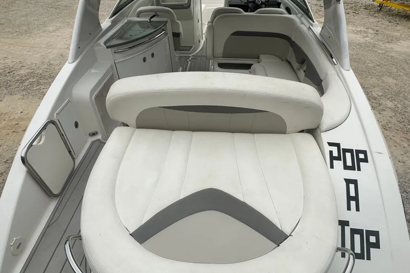 Slide: The Image of 2007 Chaparral 276 SSX boat interior with white seating and "Pop A Top" text. - 7