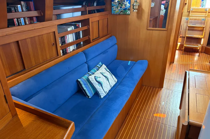 Slide: The Image of Luxurious 1989 Cambria 44/46 yacht interior with blue sofa and wooden accents. - 20