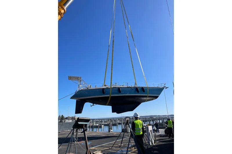 Slide: The Image of 1989 Cambria 46 sailboat being lifted by crane at marina. - 9