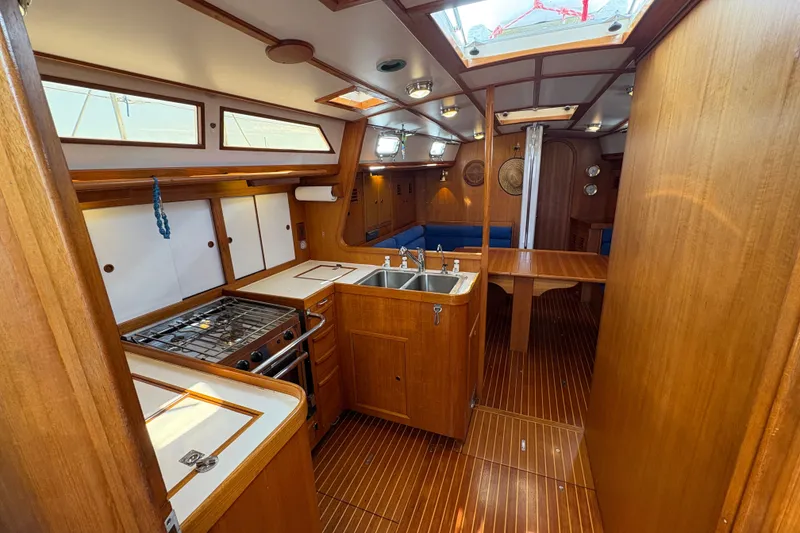 Slide: The Image of 1989 Cambria 44/46 yacht interior with wooden cabinetry and kitchen area. - 21