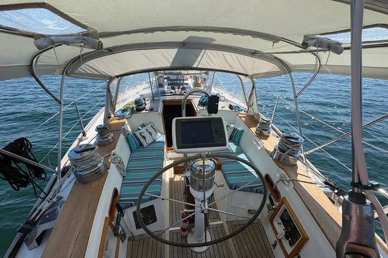 Slide: The Image of Cockpit of 1989 Cambria 44/46 sailboat with striped seating and navigation equipment. - 35