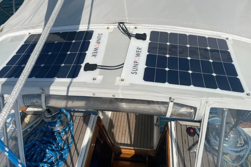 Slide: The Image of Solar panels on a 1989 Cambria 44/46 sailboat, enhancing energy efficiency. - 13