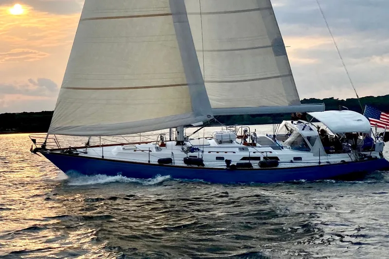 The Image of Sailing yacht Cambria 46 from 1989 gliding on water at sunset. - 0