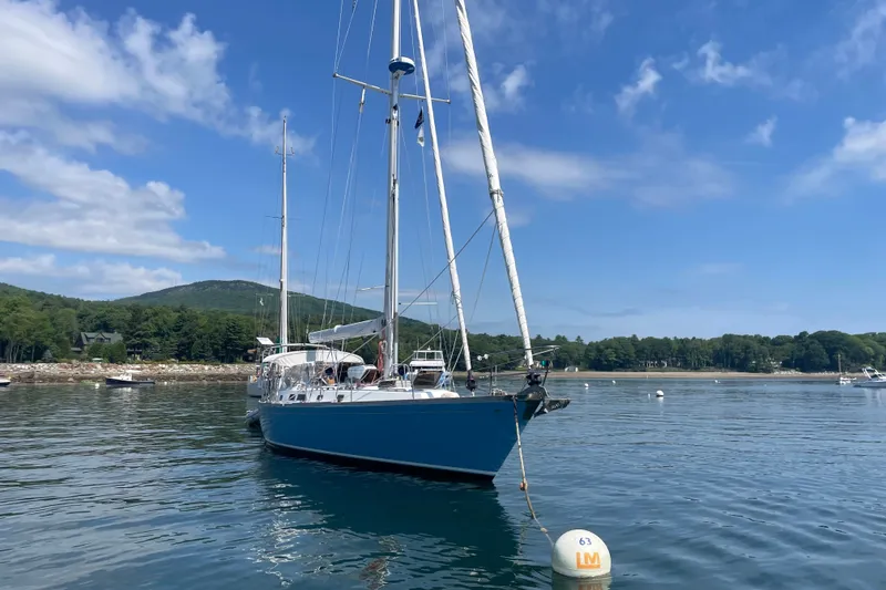 Slide: The Image of Sailboat Cambria 44/46, 1989 model, anchored in scenic coastal waters. - 14