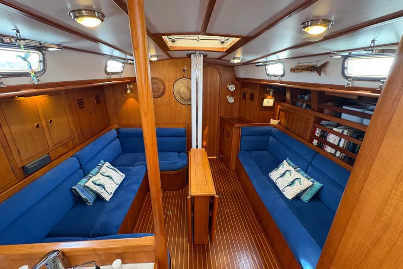 Slide: The Image of Luxurious 1989 Cambria 44/46 yacht interior with blue seating and wooden accents. - 3