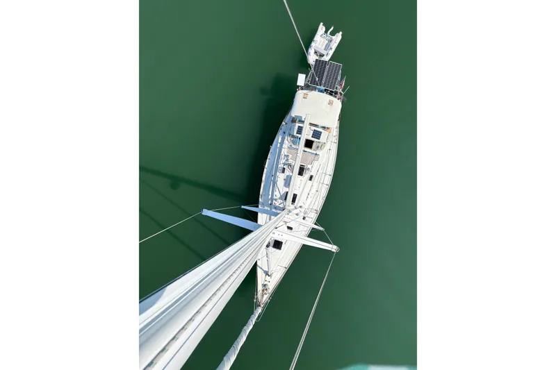 Slide: The Image of Aerial view of 1989 Cambria 46 sailboat on calm green water. - 38