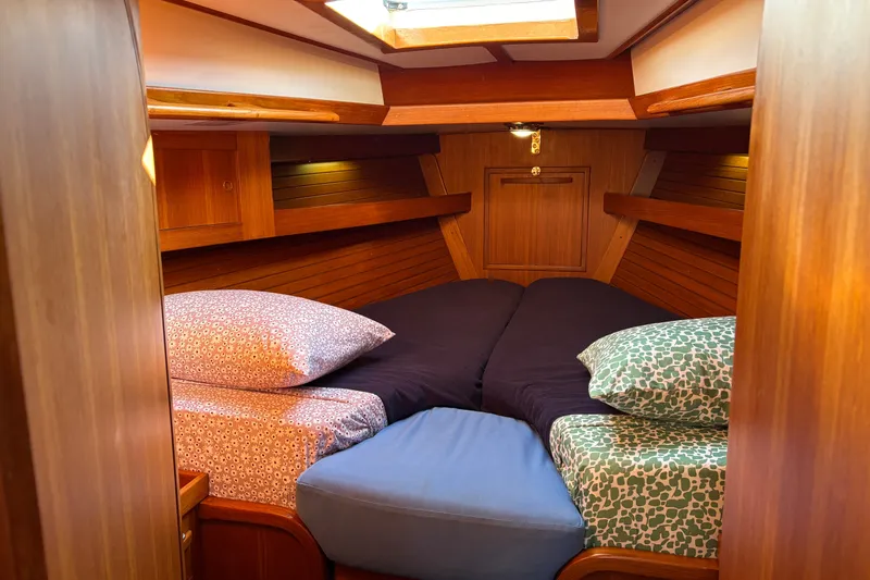 Slide: The Image of Cozy cabin interior of 1989 Cambria 44/46 sailboat with wooden finish and comfortable bedding. - 27
