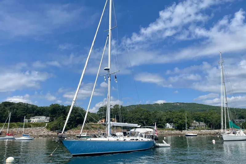 Slide: The Image of Sailboat Cambria 44/46, 1989 model, anchored in scenic harbor with blue sky. - 1