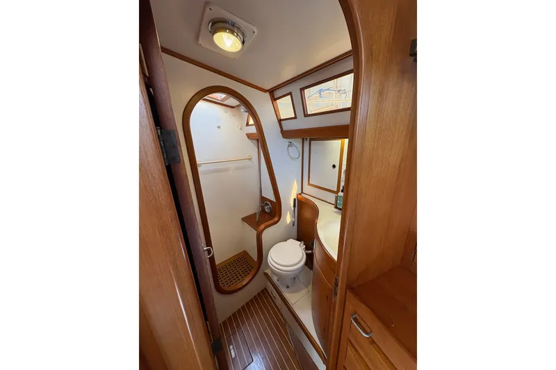 Slide: The Image of 1989 Cambria 44/46 yacht bathroom with wooden accents and compact design. - 25