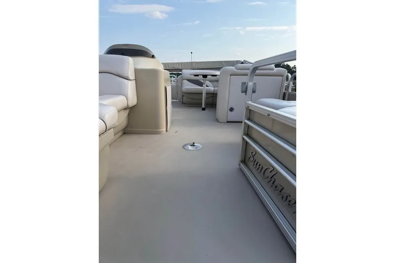 Slide: The Image of 2017 SMOKERCRAFT pontoon boat interior with beige seating and open deck space. - 3