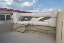 Slide: The Image of 2017 SMOKERCRAFT boat interior with beige seating under a cloudy sky. - 7