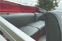Slide: The Image of 2017 SMOKERCRAFT boat interior with gray seating and red accents. - 13