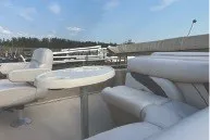 Slide: The Image of 2017 SMOKERCRAFT boat interior with white seating and table under blue sky. - 4