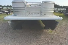 Slide: The Image of 2017 SMOKERCRAFT pontoon boat on gravel, front view. - 2