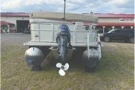 Slide: The Image of 2017 SMOKERCRAFT pontoon boat with outboard motor on grassy area. - 8