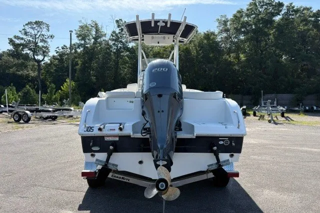 Slide: The Image of 2020 Sea Hunt Ultra 225 boat with outboard motor, parked on a trailer. - 2