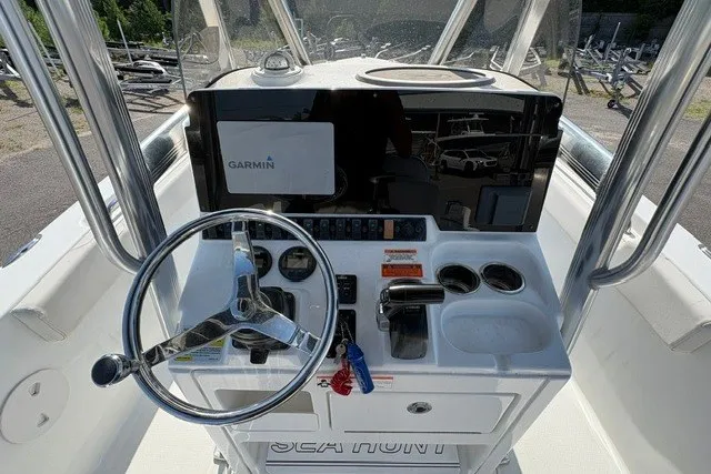 Slide: The Image of 2020 Sea Hunt Ultra 225 boat console with Garmin display and steering wheel. - 10