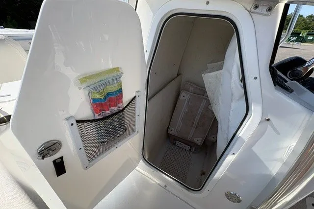 Slide: The Image of Open storage compartment on a 2020 Sea Hunt Ultra 225 boat. - 11