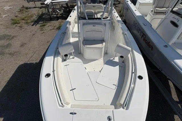 Slide: The Image of 2020 Sea Hunt Ultra 225 boat, white interior, spacious seating, and storage compartments. - 14