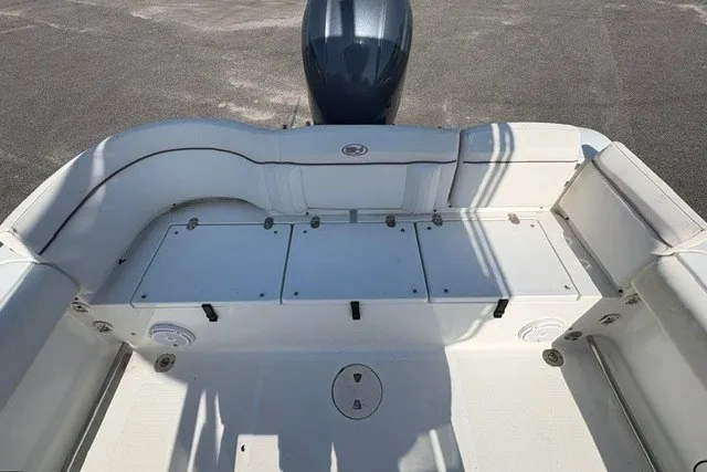 Slide: The Image of 2020 Sea Hunt Ultra 225 boat interior with cushioned seating and storage compartments. - 6