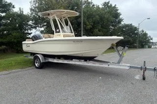 The Image of 2017 Scout 195 Sportfish boat on trailer in parking lot. - 0