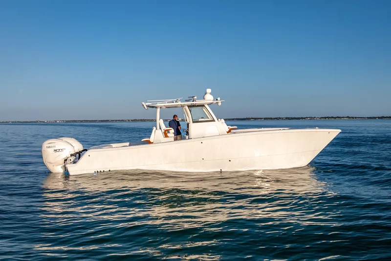 Slide: The Image of 2026 Freeman 35 boat on calm blue water under clear sky. - 13