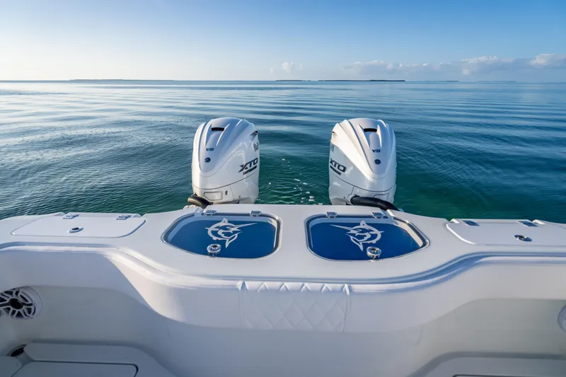 Slide: The Image of 2026 Freeman 35 boat with dual outboard engines on calm ocean waters. - 31