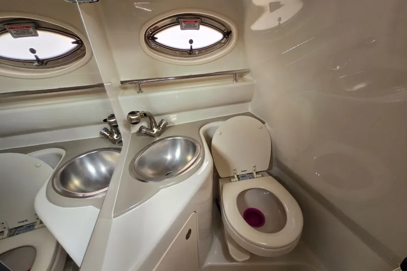 Slide: The Image of Compact bathroom in 2006 Sea Ray 240 Sundancer boat with sink and toilet. - 48