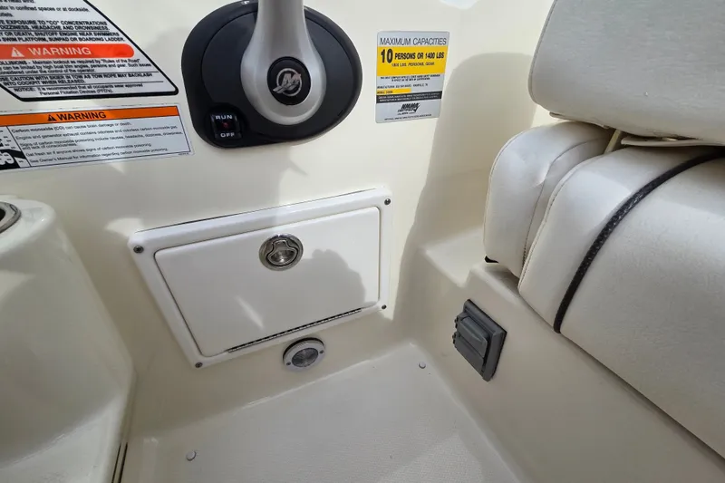 Slide: The Image of Interior of 2006 Sea Ray 240 Sundancer boat showing control panel and seating. - 27