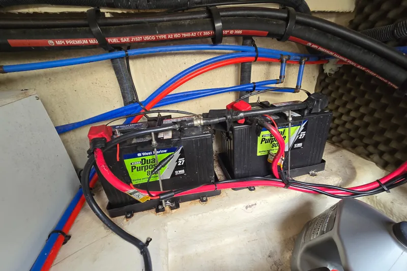 Slide: The Image of Batteries and wiring inside a 2006 Sea Ray 240 Sundancer boat engine compartment. - 35