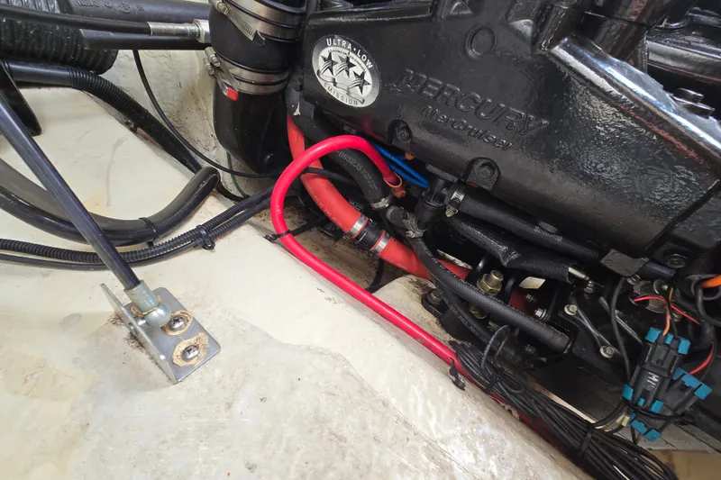 Slide: The Image of Engine compartment of a 2006 Sea Ray 240 Sundancer with Mercury MerCruiser components. - 33