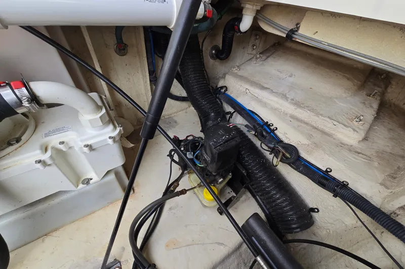 Slide: The Image of Engine compartment of a 2006 Sea Ray 240 Sundancer boat, showing mechanical components and wiring. - 37