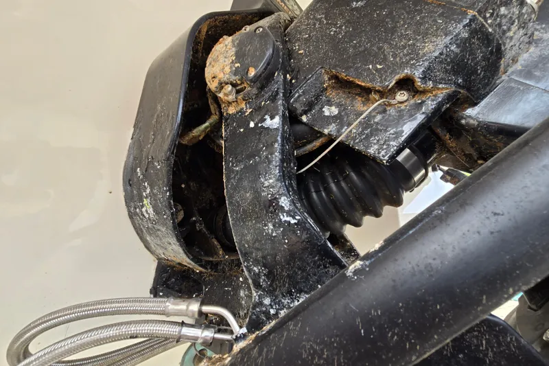 Slide: The Image of Close-up of a 2006 Sea Ray 240 Sundancer boat engine with visible wear and corrosion. - 13