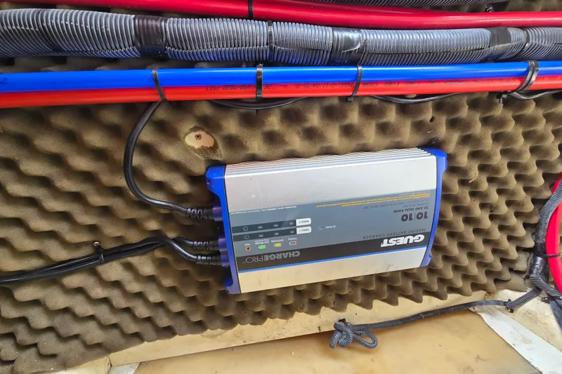 Slide: The Image of Marine battery charger in a 2006 Sea Ray 240 Sundancer boat, surrounded by cables. - 40