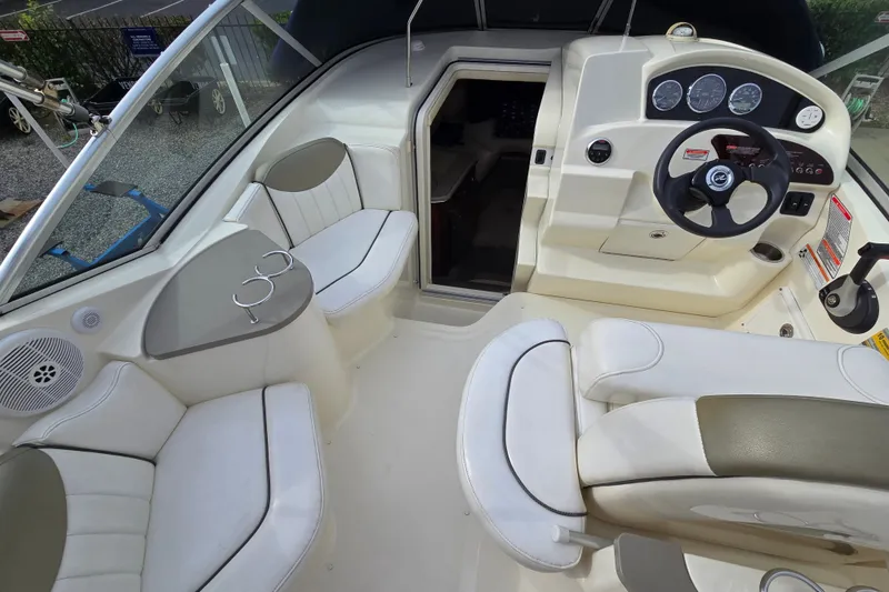 Slide: The Image of Interior of 2006 Sea Ray 240 Sundancer boat with seating and steering console. - 18